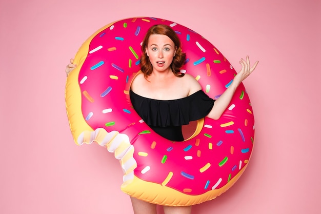 Woman wearing a swimsuit with an inflatable swim ring