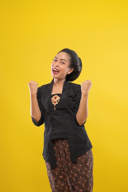 Woman wearing traditional javanese clothes excited