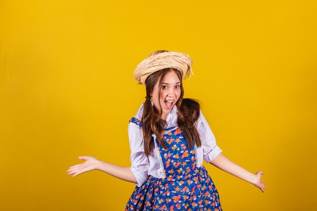 Woman wearing typical clothes for the festa junina surprised wow incredible