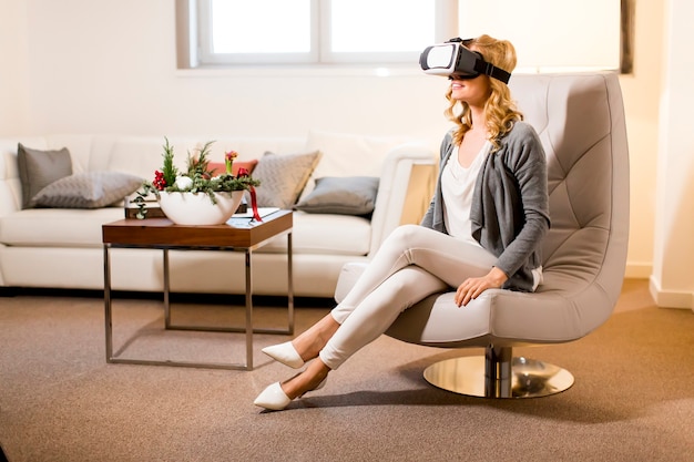 Woman wearing virtual reality goggles in the room