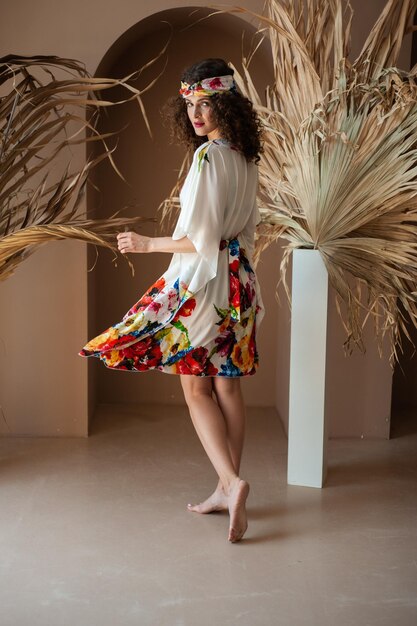 Woman wearing a white dress with a floral print