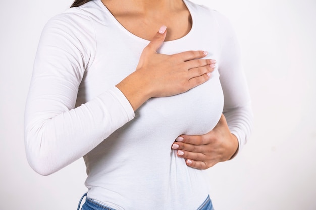 Woman Wearing A White Tank Top Checking Her Breast, Breast Self-Exam (BSE)