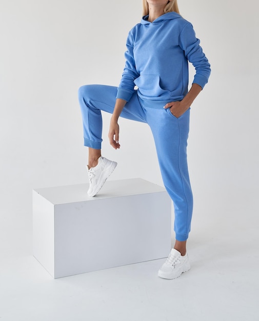 Woman wears azure blue textile sport outfit