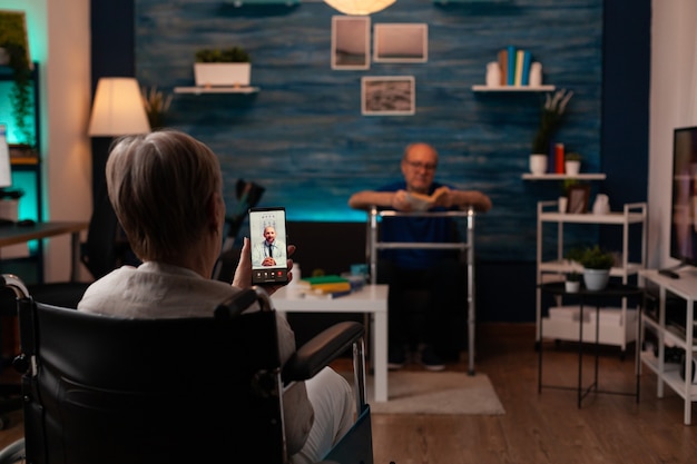 Woman in wheelchair calling doctor using video call