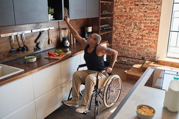 Woman in Wheelchair Cooking in Kitchen