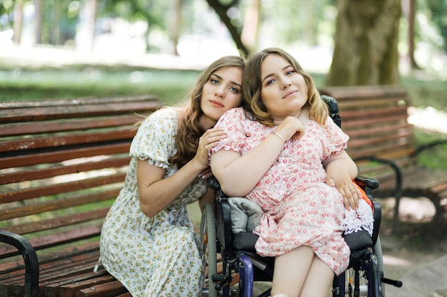 Woman in wheelchair enjoying time with her friend at park