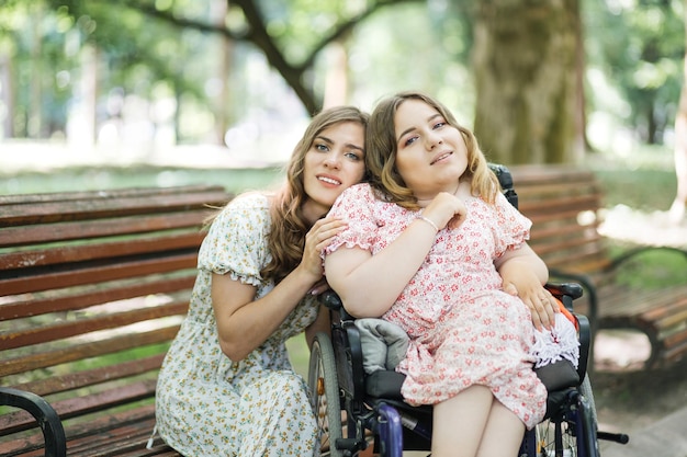 Woman in wheelchair enjoying time with her friend at park