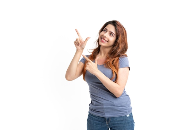 Woman on white background pointing fingers up