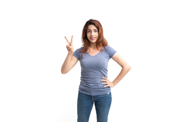 Woman on white background with victory fingers