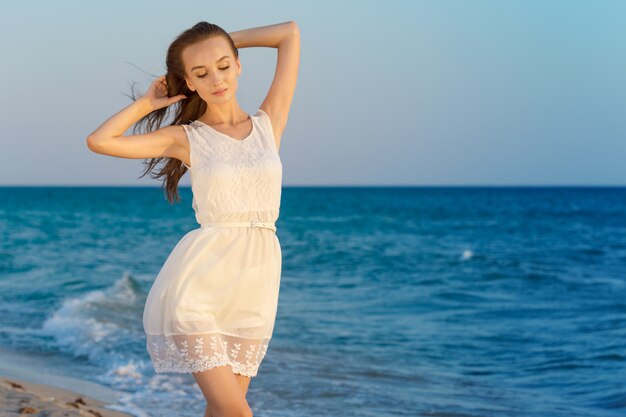 Woman in a white dress on beach