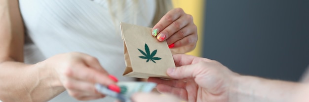 A woman in a white dress gives money and receives a bag of marijuana courier delivers the order