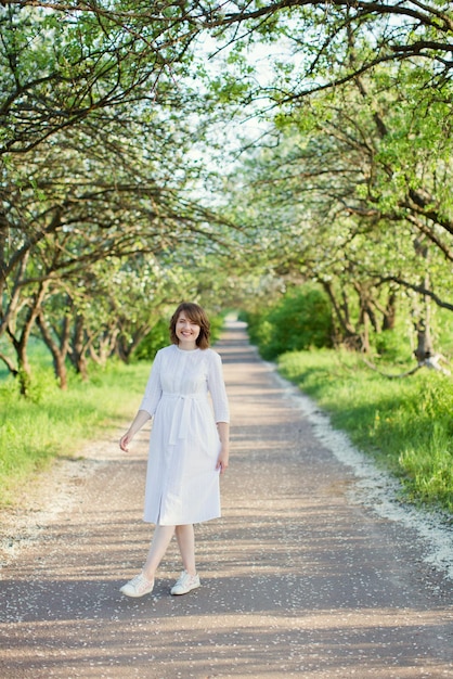 Woman in white dress spring garden