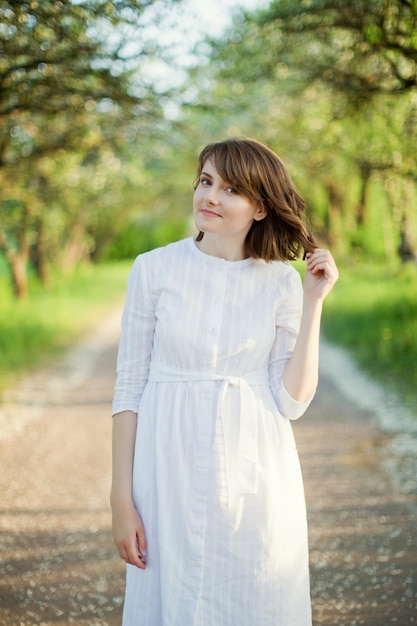 Woman in white dress spring garden