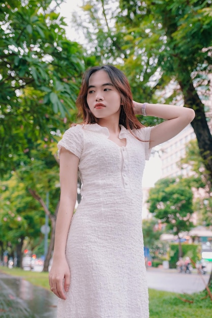 A woman in a white dress with a black collar