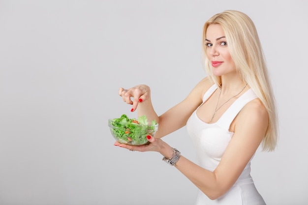 Woman in white dress with fresh salad