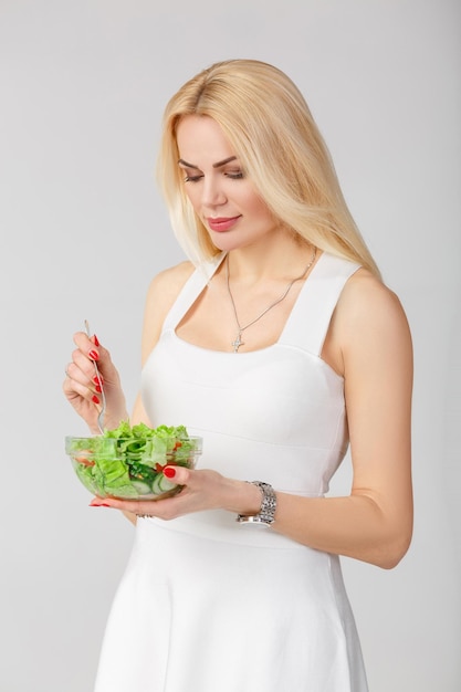 Woman in white dress with fresh salad