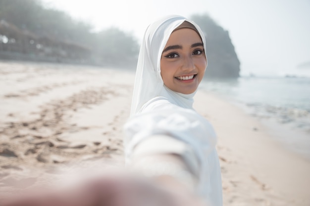 Woman in white scarf taking selfie