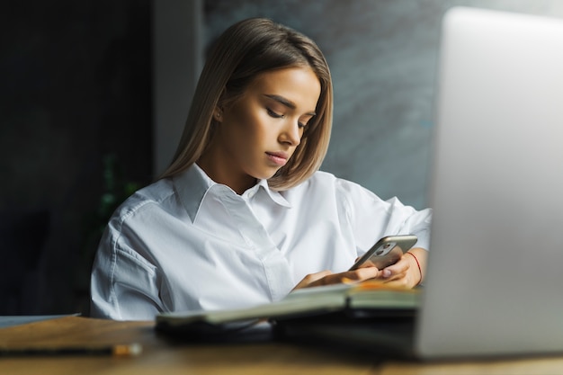 Woman in white shirt communicating online social media