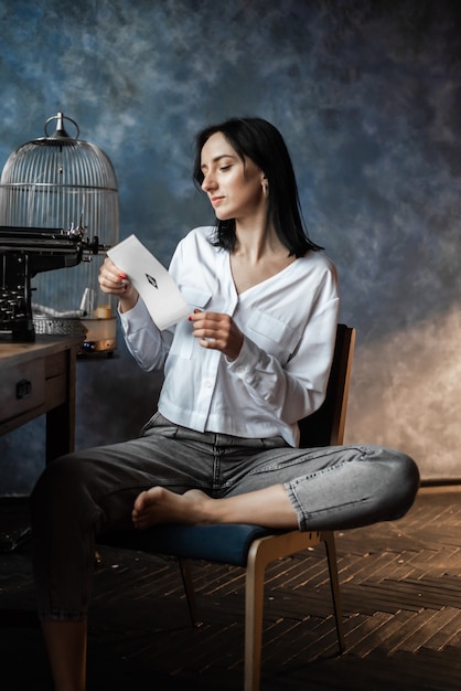 Woman in white shirt and jeans at home