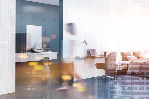 Woman in a white studio flat with a double bed, a home office corner and a bathroom in the background. 3d rendering mock up toned image double exposure blurred