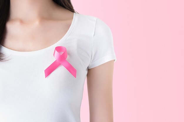 Woman in white t-shirt with pink ribbon breast cancer awareness campaign 