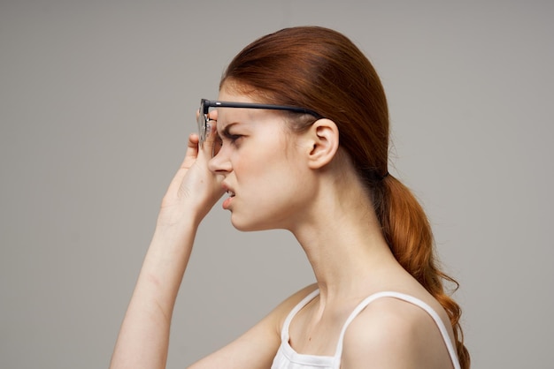 Woman in white tshirt vision problems myopia light background