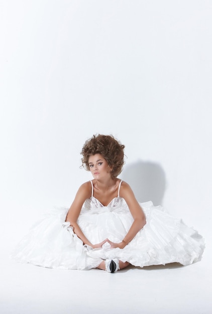 A woman in white wedding dress over white background.