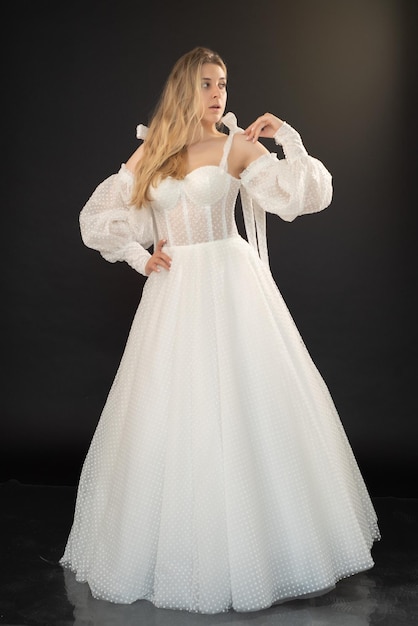 A woman in a white wedding dress with a long sleeved top