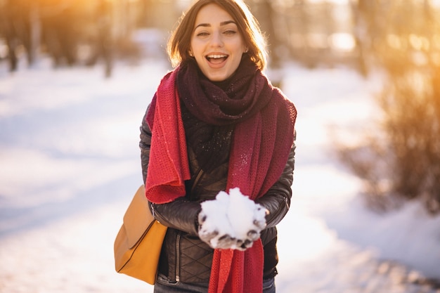 Woman in winter blowing snow