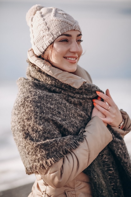 Woman in winter by the lake