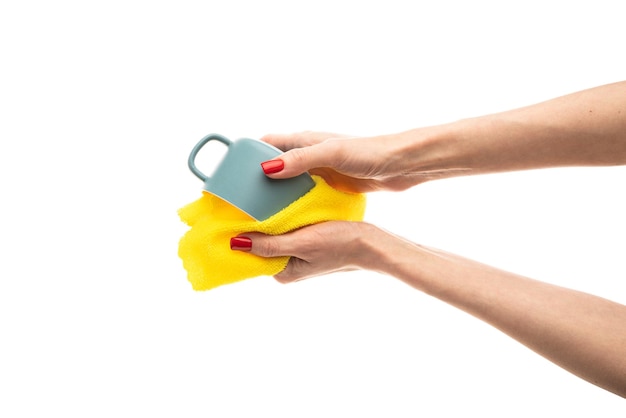 Woman wiping blue cup with towel in kitchen closeup