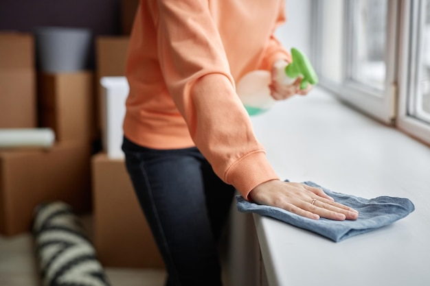 Woman wiping dust at home