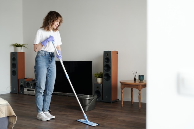 Woman wiping floor with mop