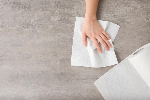 Woman wiping table with paper towel