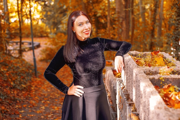 woman in a witch costume in an autumn forest or castle halloween