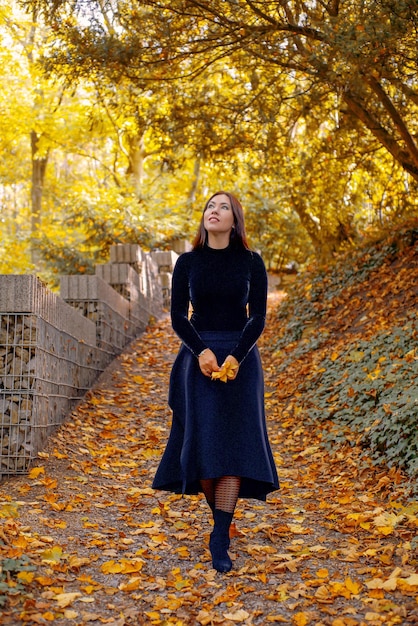 Photo woman in a witch costume in an autumn forest or castle halloween