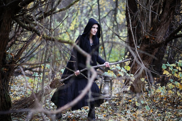 A woman in a witch suit in a forest