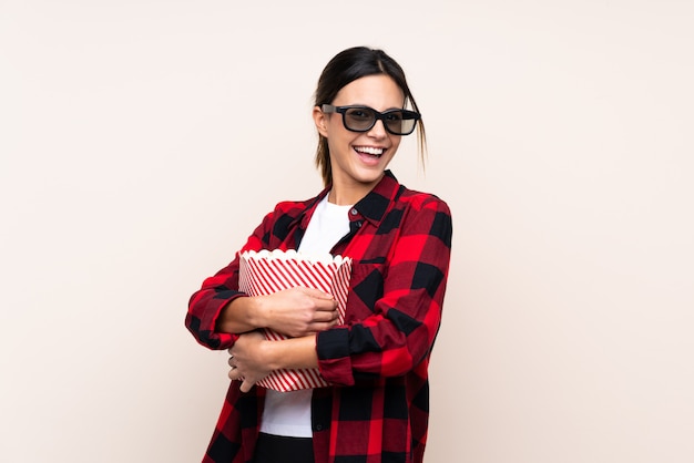 Woman with 3d glasses and holding a big bucket of popcorns