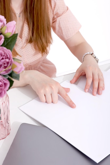 写真 woman with a book magazine and laptop on a white background student business mockup