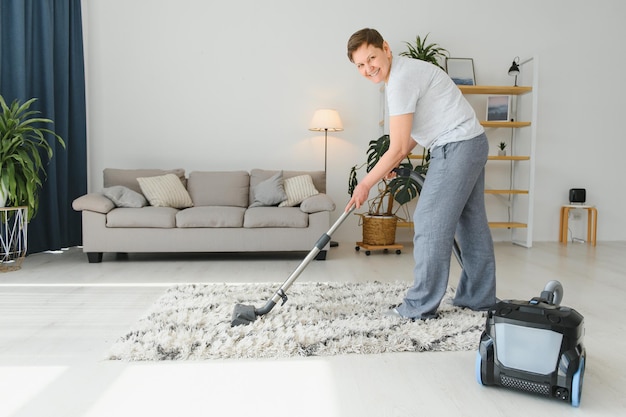 Woman with accumulator vacuum cleaner