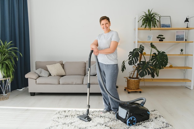 Woman with accumulator vacuum cleaner