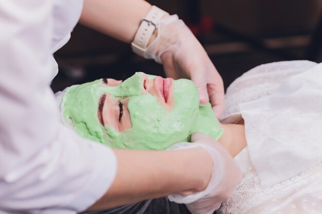 Woman with algae cream treatment for skin