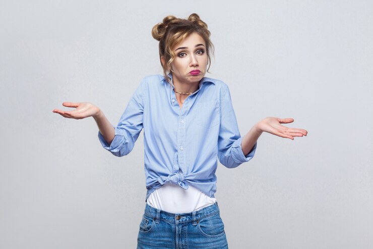 Photo woman with arms out shrugging her shoulders saying who cares so what