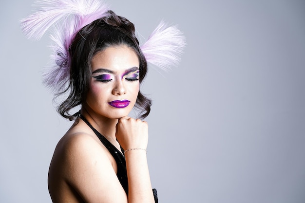 Woman with artistic makeup on white background