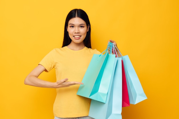 Woman with Asian appearance fashion shopping posing isolated background unaltered