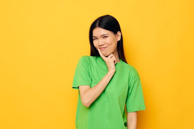 Woman with Asian appearance posing in green tshirt emotions copyspace Lifestyle unaltered