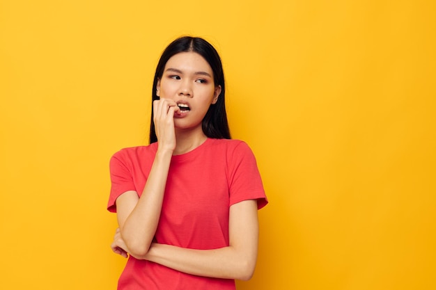 Woman with Asian appearance red tshirts posing modern style isolated background unaltered