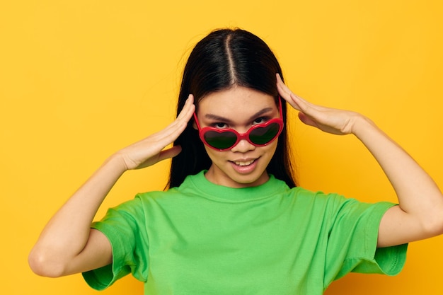 Woman with asian appearance sunglasses fun posing casual isolated background unaltered