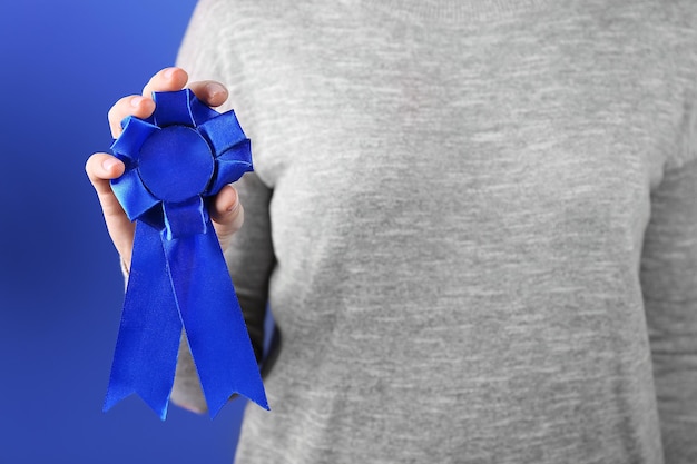 Woman with award ribbon closeup