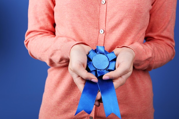 Photo woman with award ribbon closeup